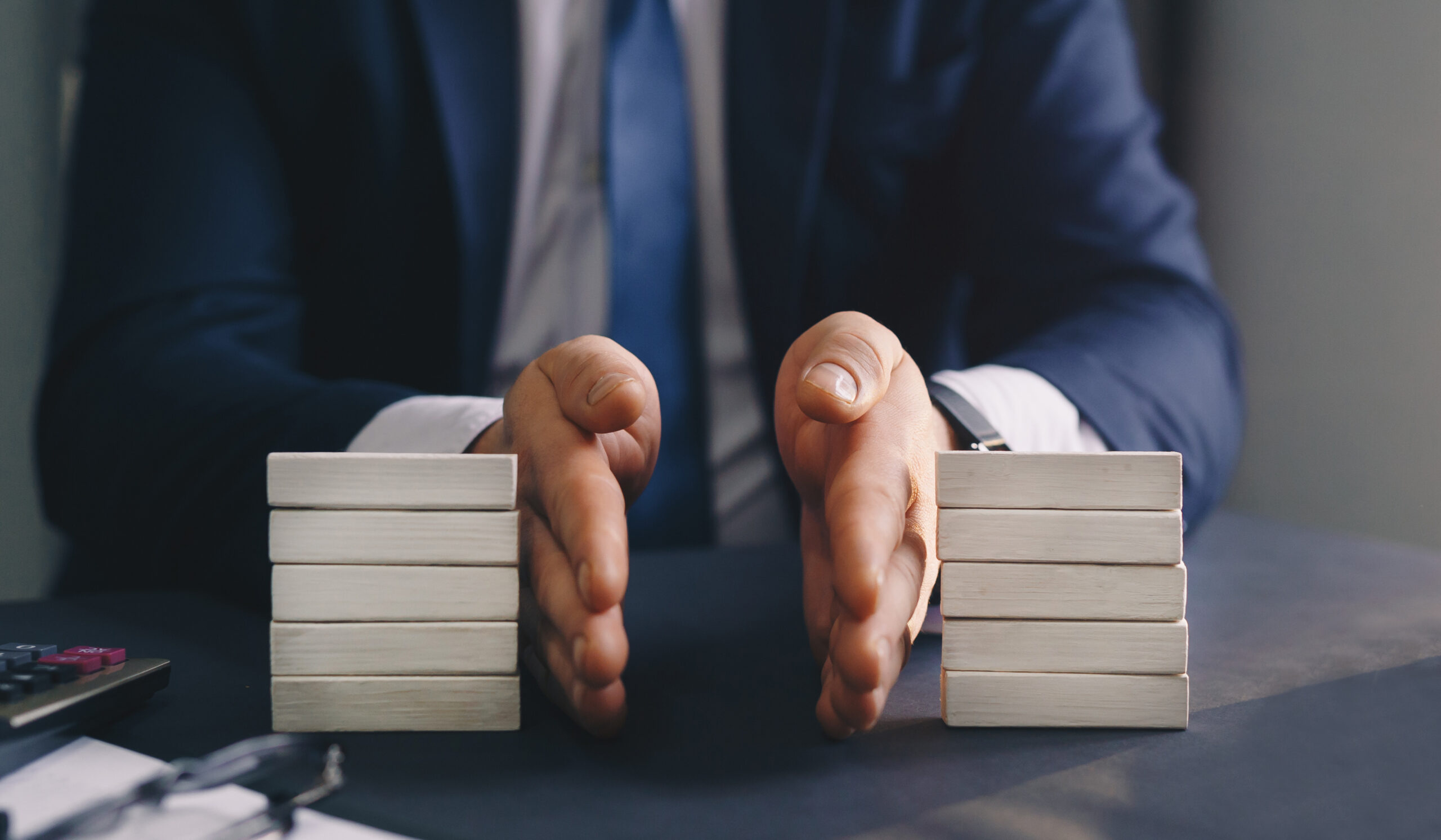 Businessman separates wooden block. Property division. Divorce